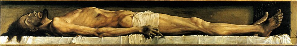Le corps décharné du Christ mort, allongé de profil dans une niche étroite