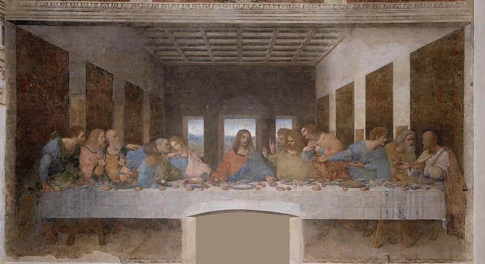 Le Christ au centre d'une longue table, entouré des douze apôtres agités
