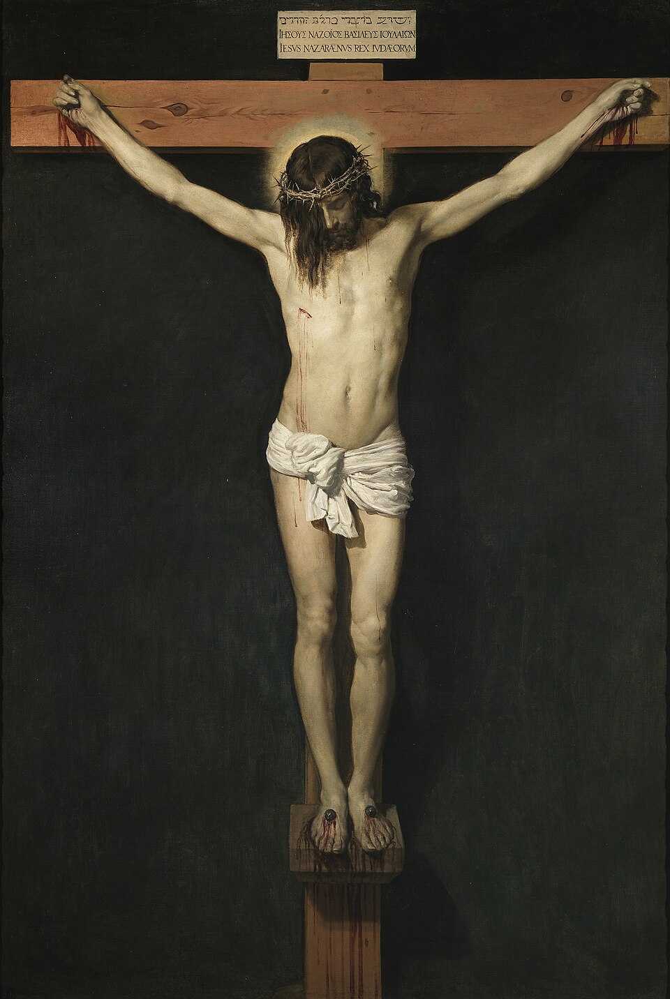 Le Christ en croix sur fond noir, la tête inclinée